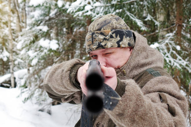 istock A hunter with a gun. Winter hunting. Huntsman. 1187172786