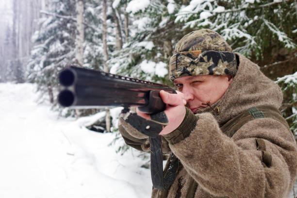 istock A hunter with a gun. Winter hunting. Huntsman. 1187172792