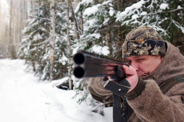 istock A hunter with a gun. Winter hunting. Huntsman. 1187172831