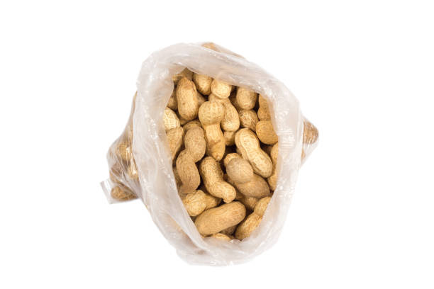 istock Nuts shelled peanuts in bag on white background 1187173535