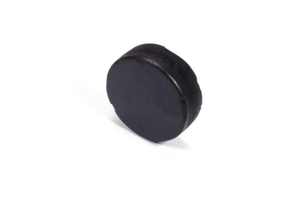 istock The old hockey puck on white background 1187173552