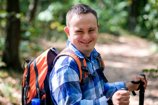 In love with nature Teenager with Down syndrome hiking in forest disabled person hiking outdoors stock pictures, royalty-free photos & images
