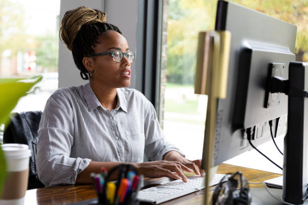 istock Mid adult secretary works diligently on desk top computer 1187176032