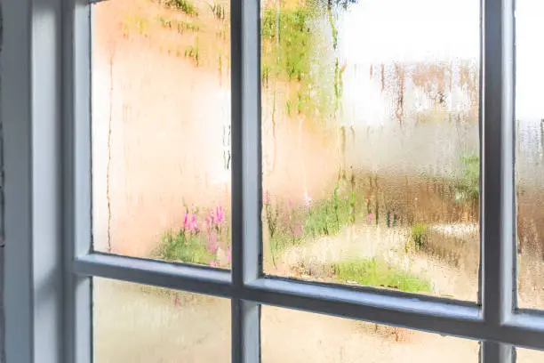 Condensation on an old window of a home