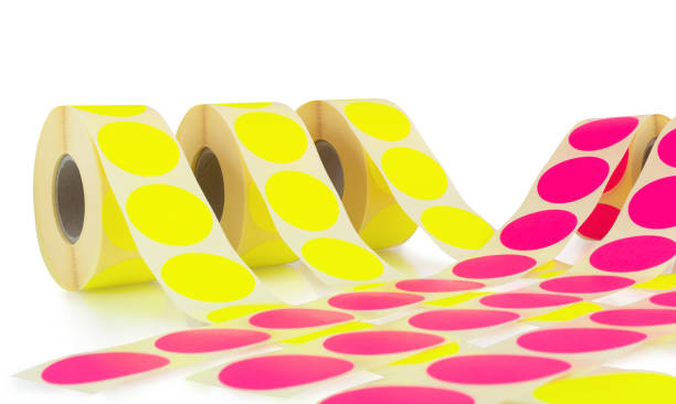 istock Colored label rolls isolated on white background with shadow reflection. Color reels of labels for printers. Labels for direct thermal or thermal transfer printing. Close-up shot. Label wallpaper. 1187178106