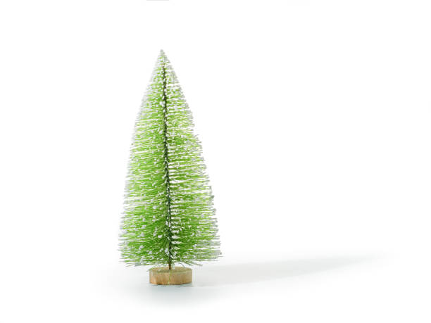 Small red artificial Christmas fir isolated on white background. Sparse composition with copy space