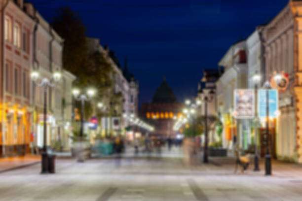 istock Defocused image, bokeh effect. Evening or night cityscape. Long exposure. People walk on a pedestrian street. Nizhny Novgorod, Russia 1187179392
