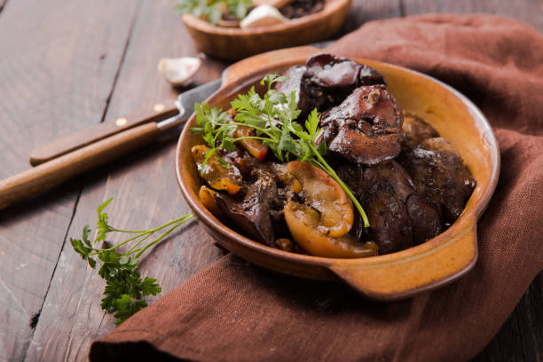 istock Stewed chicken liver with apple on wooden table 1187180681