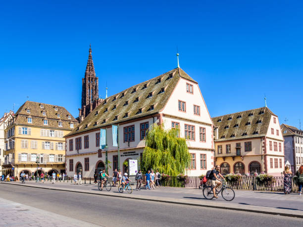 The Historical museum of Strasbourg, France, and steeple of Notre-Dame cathedral. Strasbourg, France - September 15, 2019: The Historical Museum is located in the listed building of the former slaughterhouse on the river Ill, near Notre-Dame cathedral in the historic district. historical museum stock pictures, royalty-free photos & images