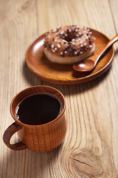 istock Wooden cup of coffee and donut 1187181185