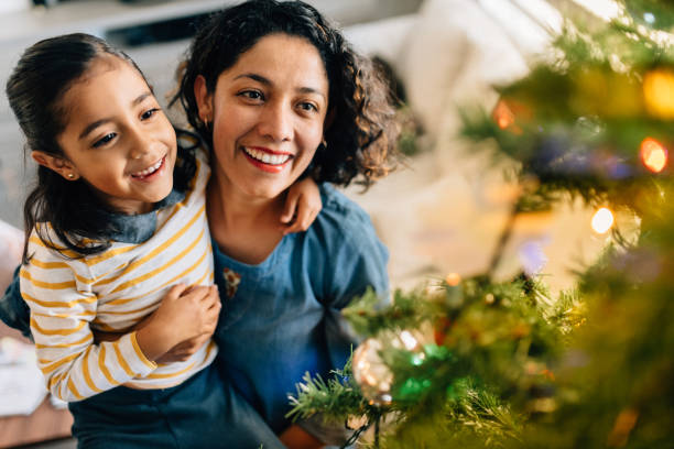 istock Mother and daughter decorating Christmas Tree 1187183838