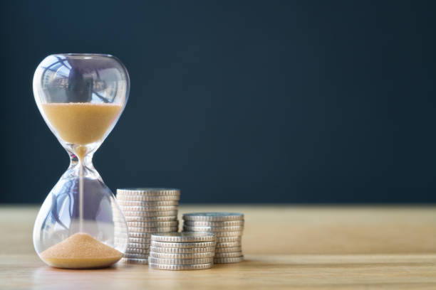 Savings time Time and stack of coins. time stock pictures, royalty-free photos & images