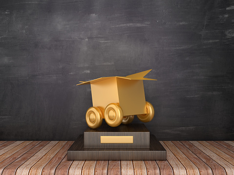 Trophy with Box on Wheels on Wood Floor - Chalkboard Background - 3D Rendering