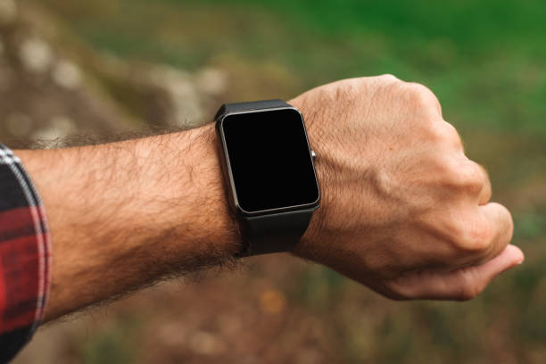 Smartwatch on male hiker hand, blank mock up screen close up with selective focus