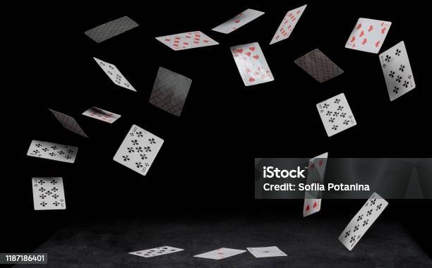 Playing Cards Fall On A Black Table Stock Photo - Download Image Now - Playing Card, Flying, Falling