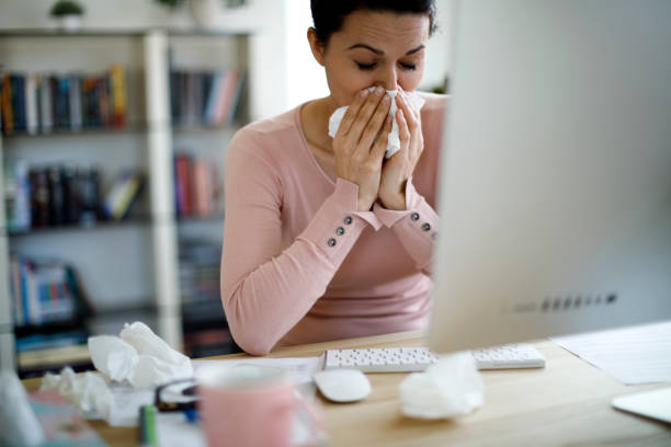 istock Woman blowing her nose 1187187219