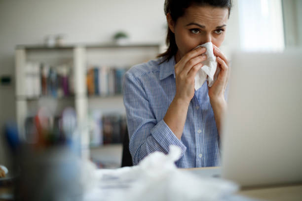 istock Woman blowing her nose 1187187222