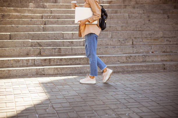 istock Woman going to go up the stairs 1187187471