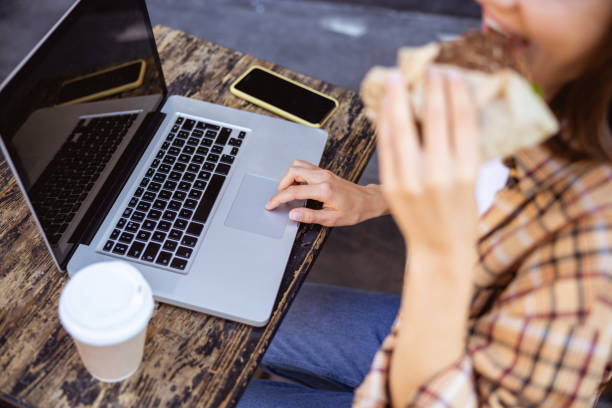 istock Young woman eating during her coffee break 1187187510