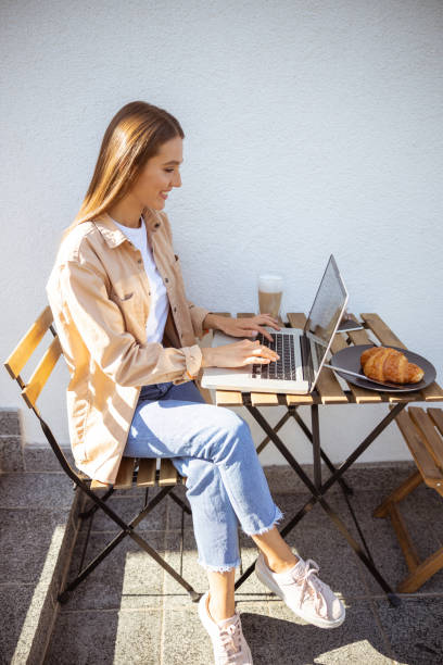 istock Cheerful self employed woman working in the cafe 1187187634