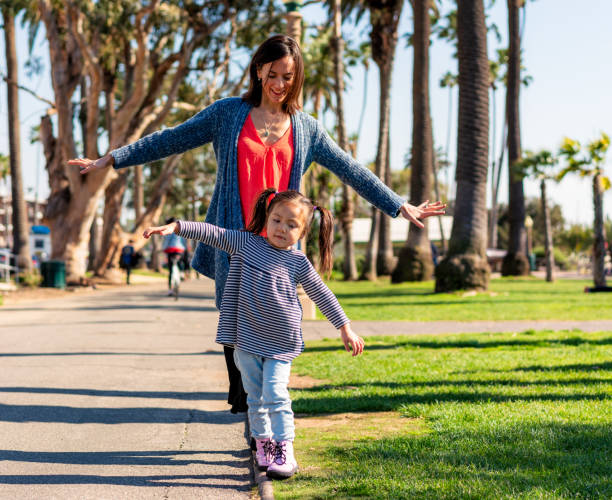 istock Mother and daugher balancing competition 1187189440