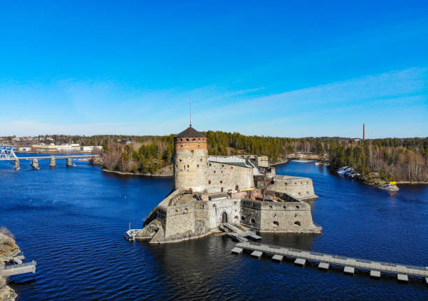 Beautiful aerial view of Olavinlinna, Olofsborg ancient fortress, the 15th-century medieval three - tower castle located in Savonlinna city on a sunny summer day, Finland. Shooting from a quadcopter. Beautiful aerial view of Olavinlinna, Olofsborg ancient fortress, the 15th-century medieval three - tower castle located in Savonlinna city on a sunny summer day, Finland. Shooting from a quadcopter saimaa stock pictures, royalty-free photos & images