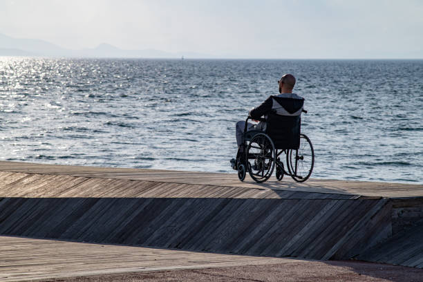 istock Man on wheelchair on the beach 1187194537
