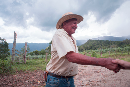 Pindamonhangaba, Sao Paulo, Brazil - December 26, 2015: Farmer greets driver who stopped to ask about destination path to follow in the  countryside of Paraiba Valley.