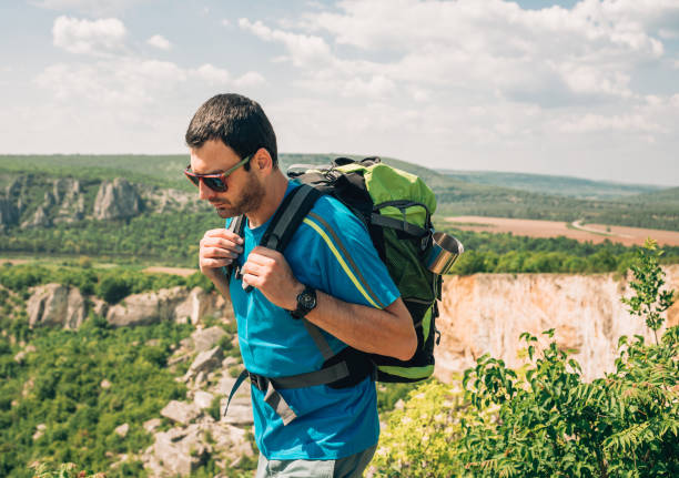 istock Male hiker wanders through hills 1187196032