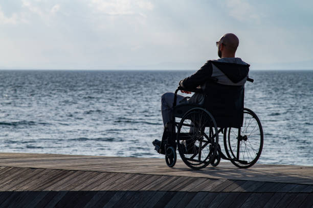 istock Man on wheelchair on the beach 1187196370