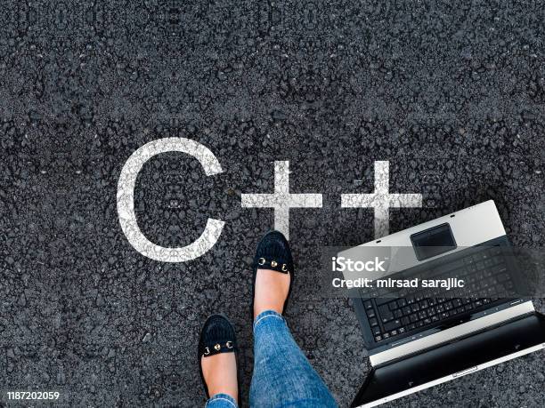 A Woman Steps To A Laptop And C On Asphalt Road Stock Photo - Download Image Now - Activity, Adult, Applying