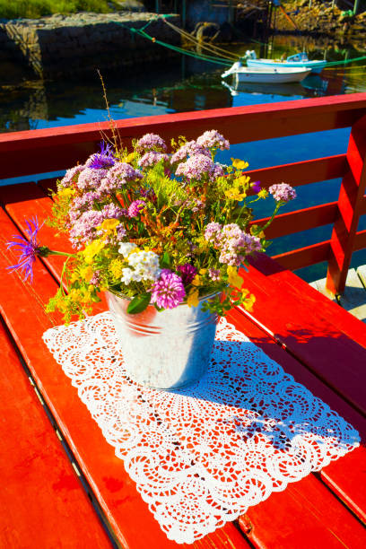Village of Å, Norway - July 20, 2018: Norwegian summer herbs on the lace tablecloth, Lofoten Islands