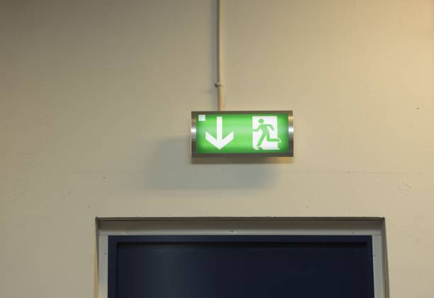 istock Close up view of green emergency exit plate. Safety concept. 1187203154