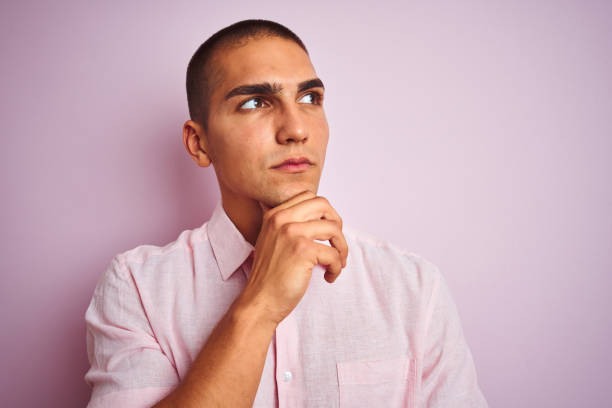 istock Young handsome man wearing elegant shirt over pink isolated background serious face thinking about question, very confused idea 1187204212