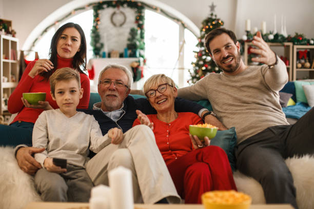 istock Multi generation family watching TV and eating snacks 1187204605