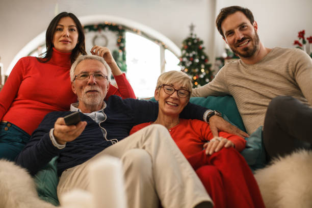 istock Two generation family bonding while watching TV on Christmas 1187204606