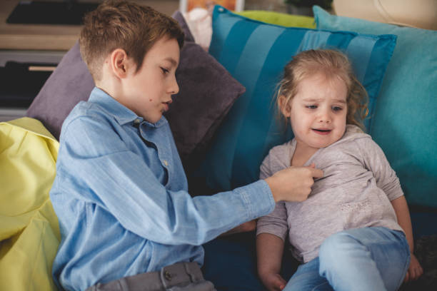 istock Boy checking his little sister's temperature 1187205937