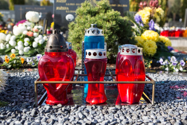 istock People remembering their loved ones who died; on the cemetery 1187206880