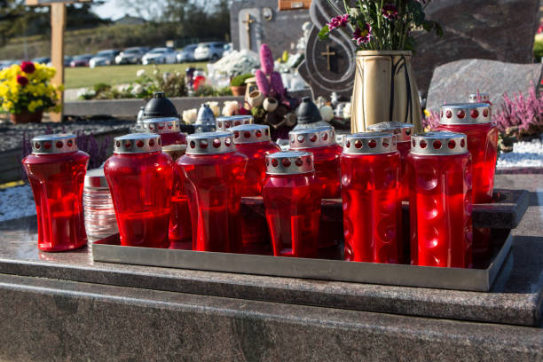 istock People remembering their loved ones who died; on the cemetery 1187207468
