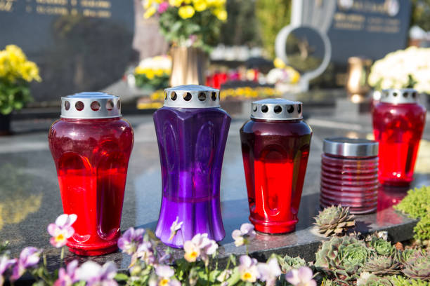 istock People remembering their loved ones who died; on the cemetery 1187207513
