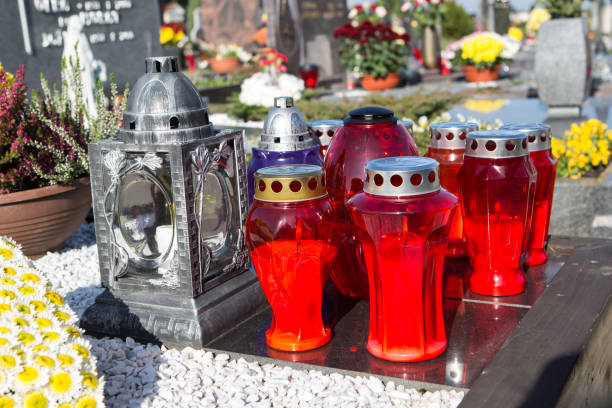 istock People remembering their loved ones who died; on the cemetery 1187208076