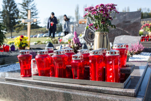 istock People remembering their loved ones who died; on the cemetery 1187208101
