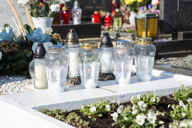 istock People remembering their loved ones who died; on the cemetery 1187208139