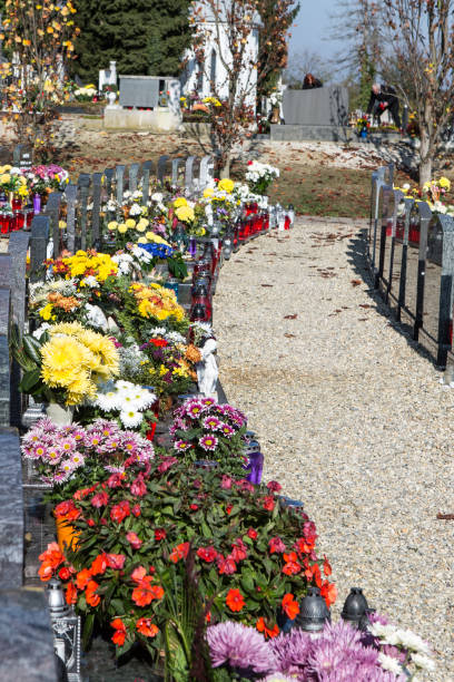 istock People remembering their loved ones who died; on the cemetery 1187208161