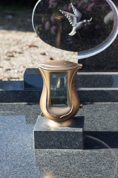 istock People remembering their loved ones who died; on the cemetery 1187208193