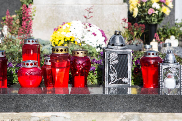 istock People remembering their loved ones who died; on the cemetery 1187208208