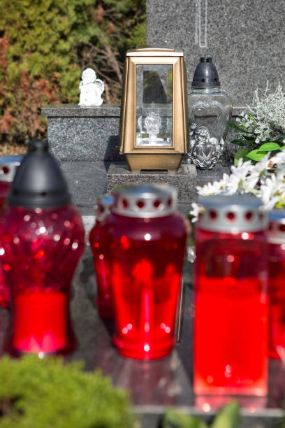 istock People remembering their loved ones who died; on the cemetery 1187208263
