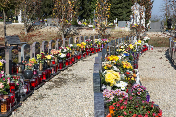 istock People remembering their loved ones who died; on the cemetery 1187208474
