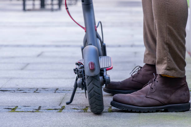 istock Feet next to the electric scooter 1187208538