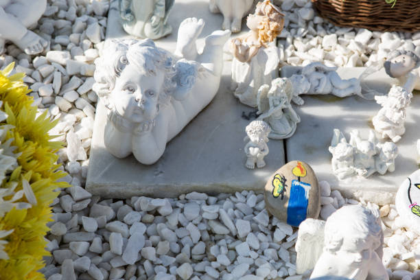 istock People remembering their loved ones who died; on the cemetery 1187208569